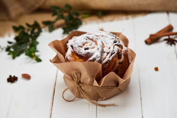 Easter cake decorated by raisins and icing sugar on white wooden background, Traditional Kulich, Paska  ready for celebration