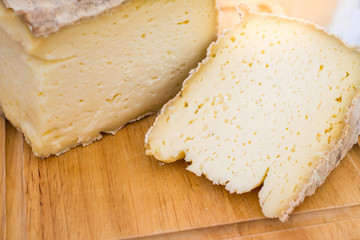 Aged soft cheese on a  served on wooden background. Dairy delicacies.