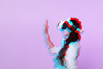 Obraz premium Woman is using virtual reality headset. Image with glitch effect.