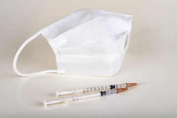 Medical syringe and protective mask. Medical and protective accessories.