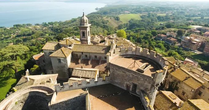 Aerial, tracking, drone shot panning towards the Museo del Duomo di Bracciano, sunny day, in Lazio, Italy