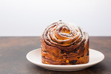 Homemade cruffin cake, made with yeast. Filled with butter, chiocolate, nuts and raisins. Minimalistic. 