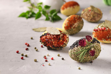 Eco-design of Easter eggs with various spices and cereals, without dyes and preservatives on a gray concrete background, Closeup