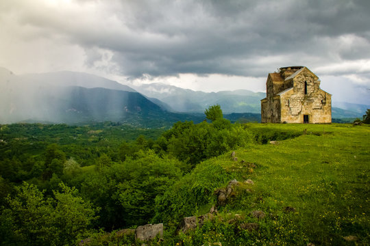 the ruins of the temple against the backdrop of a thunderstorm and rain