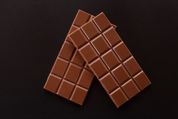 Chocolate on a dark background. Two chocolate bars