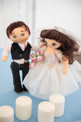 Dolls bride and groom on the wedding table.