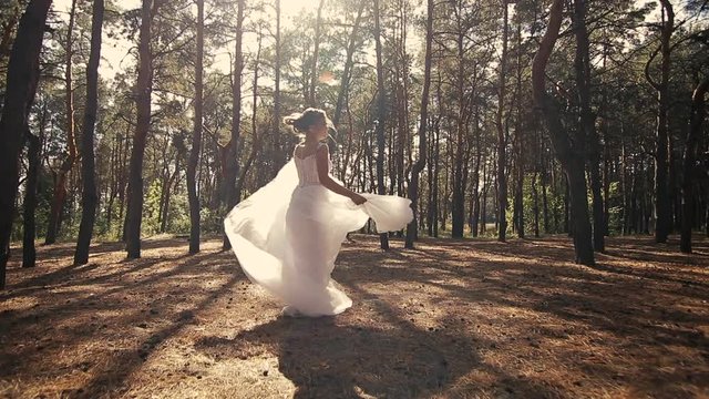 bride runs through the woods spinning a beautiful dress steadicam shoot