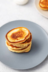 Pancakes. Stack of pancakes with honey on a gray background. Homemade breakfast