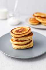 Pancakes. Stack of pancakes with honey on a gray background. Homemade breakfast