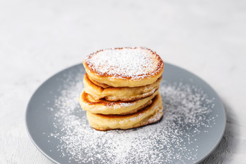 Pancakes. Stack of pancakes with honey on a gray background. Homemade breakfast