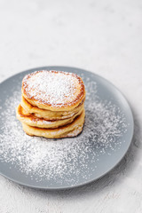 Pancakes. Stack of pancakes with honey on a gray background. Homemade breakfast