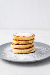 Pancakes. Stack of pancakes with honey on a gray background. Homemade breakfast