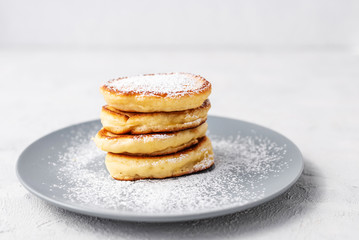 Pancakes. Stack of pancakes with honey on a gray background. Homemade breakfast