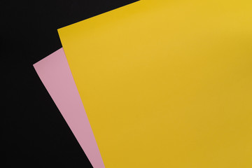 Yellow and pink paper. Paper texture background. Color. Copy space. Dark mode style. Top view. Minimal concept