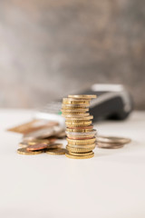 pile coin in the front and coins in the background out of focus