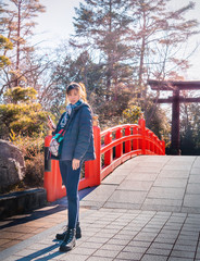 Beautiful Woman is portrait in winter clothing with Japanese Temple shrine background for Sendai...