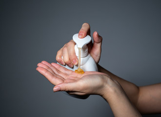 women cleaning hands with alcohol gel or antibacterial soap sanitizer. Hygiene concept. prevent the spread of germs and bacteria and avoid infections corona virus