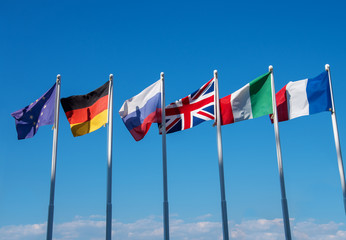 international flags against blue sky