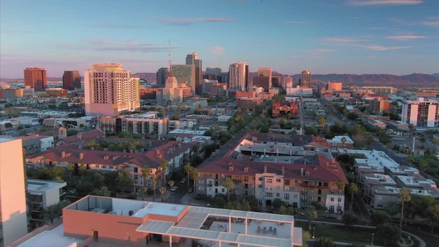 Aerial flying over downtown Phoenix city skyline at sunset. Arizona, USA