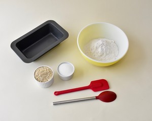 Baking ingredients with mixing bowls and kitchen utensils for making pastries and cookies