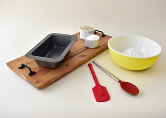 Baking ingredients with mixing bowls and kitchen utensils for making pastries and cookies