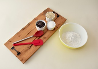 Home baking ingredients with mixing bowls and kitchen utensils 