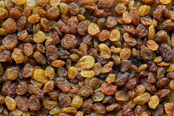 Large texture of light brown raisins, background.