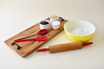 Home baking ingredients with mixing bowls and kitchen utensils 