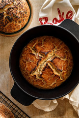 Homemade sourdough bread baked in a cast iron pot, top view