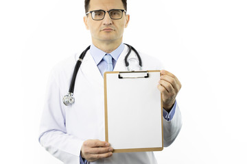 Serious male senior age doctor in white lab coat and stethoscope showing clipboard with blank paper to write on it personal message or advice. Healthcare, insurance and medical suggestion concept