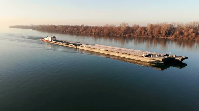 Drone video of tugboat pushing a barge on the river
