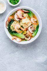 Homemade Wonton Soup with dumplings, brown mushrooms, bok choy and shrimps.
