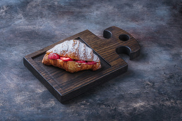 Delicious croissant with strawberry for breakfast, copy space