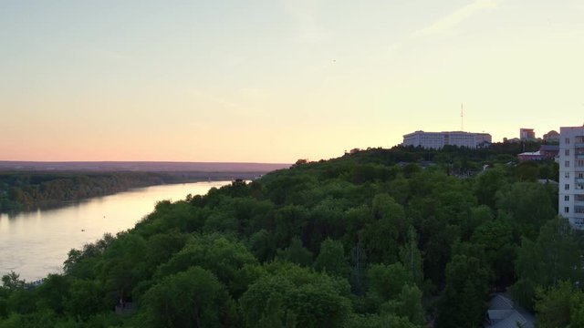 Ufa city aerial view to Monument to Salavat Yulaev and Cultural center of the city at beautiful sunset at background through Belaya river in Bashkortostan