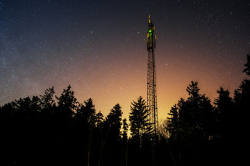 Mobile phone 4G and 5G  antenna in the woods at night.