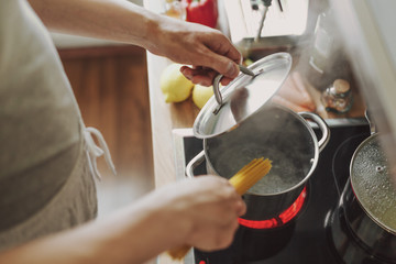 Obraz na płótnie Canvas Man cooking pasta in the kitchen