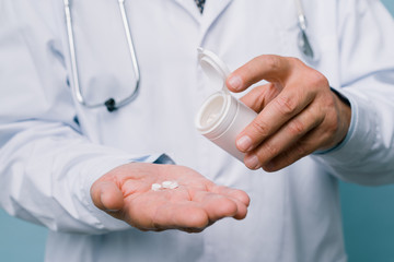 Pills in the doctor's hand. Panacea for all diseases
