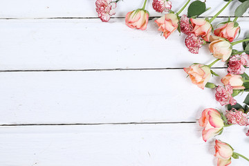 Flowers on a wooden background isolated, place for text, flat lay. Creative modern bouquet, minimal...