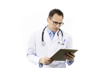 Fototapeta premium Tired male senior age doctor in white coat and stethoscope looking on clipboard with patient's diagnosis on isolated white background. Copy space. Healthcare, insurance, diagnosis, medical concept