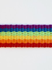 Gay pride LGBT rainbow ribbon isolated close up on a white background.