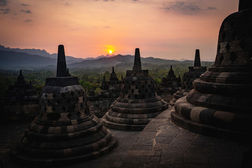 sunset over stupas of borobudur indonesia