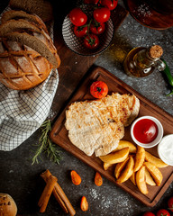 chicken fillet with potato and ketchup