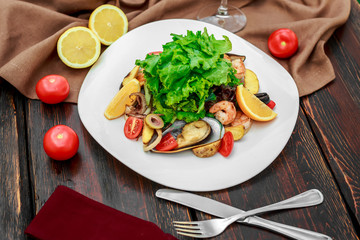 salad with seafood, with mussels and shrimps on a wooden background