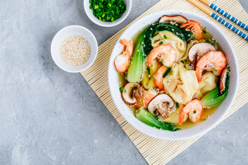 Homemade Wonton Soup with dumplings, brown mushrooms, bok choy and shrimps.
