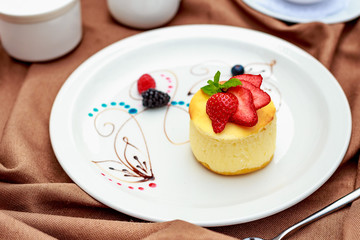 cheesecake with wild berries on a white plate
