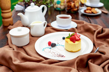 cheesecake with wild berries on a white plate