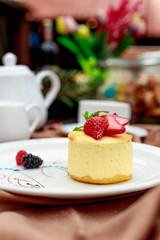 cheesecake with wild berries on a white plate