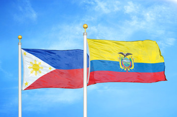 Philippines and Ecuador two flags on flagpoles and blue cloudy sky