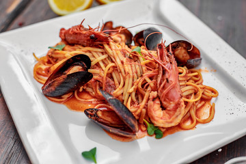 pasta with seafood, with mussels and shrimps on a wooden background