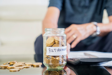 Jar full of golden coins with retirement text